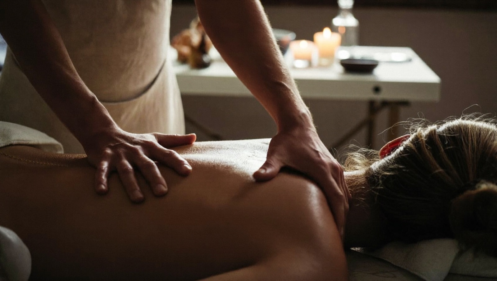 Illustrative image of a massage therapist working in a candlelit room